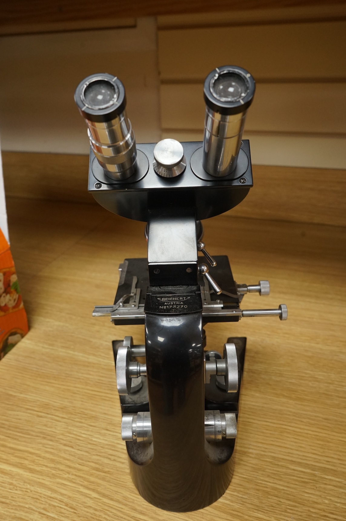 A mid 20th century Reichert, Austria binocular microscope, 34cm high.